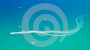 Watersports at seaside aerial minimal background. Speedboats leave spray trail on sea water photo