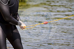 Watersports wakeboard in diving suit