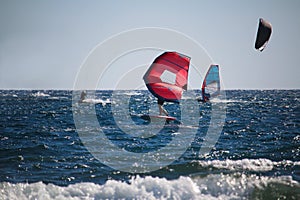 Watersports windsurfing, wingfoiling and kiteboarding at the sea