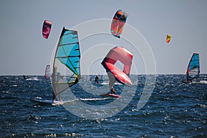 Watersports windsurfing, wingfoiling and kiteboarding at the sea