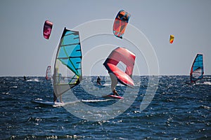 Watersports windsurfing, wingfoiling and kiteboarding at the sea photo