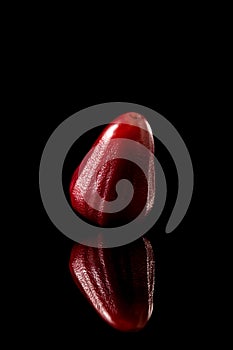 Watery rose apple on a black reflective background