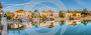 Watrer reflection of three luxurious villas in the evening