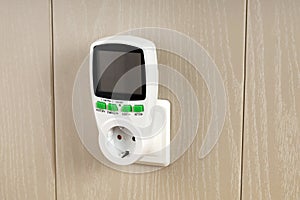 Wattmeter for measuring electricity costs in devices connected to outlet, in socket on wall