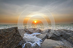 Wave attact rock and sun