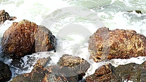 Wave attact stone near beach speed boat on sea silhouette tree