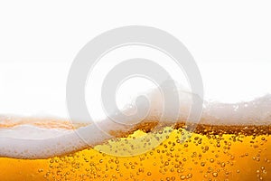 Wave of beer with froth alcoholic beverage isolated on white