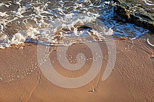 Wave of blue ocean on sandy beach. Background.