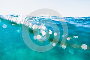 Wave in blue sea. Water texture with bokeh.