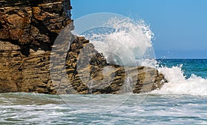 Wave breaking against the rocks on the beach of the cathedrals of Galicia Spain