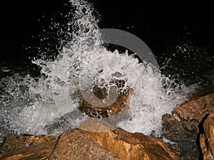 A wave breaking against the shore