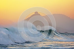 Wave breaking in Bakio near gaztelugatxe at sunset