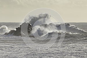 Wave breaking over sea rocks