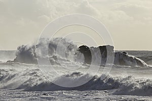 Wave breaking over sea rocks