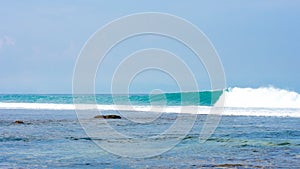 Wave breaking over shallow reef in Bali, Indonesia