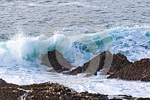 Wave breaking on rocks. Morro Bay, California.
