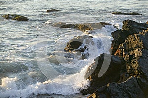 Wave breaks at the Cliff Walk, Cliffside Mansions of Newport Rhode Island photo