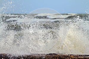 Wave crashes onto rocks