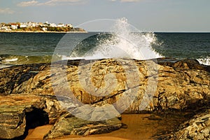 Wave crashes on a rocky shore