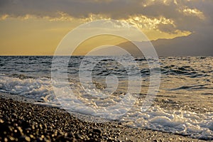 A wave crashes on the seashore