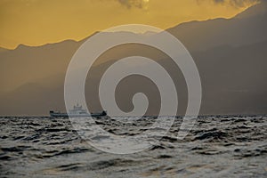 A wave crashes on the seashore