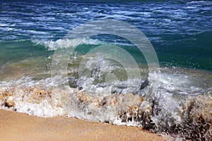 Wave crashes on to the shore. photo