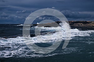 Wave crashing against rocks on a beach