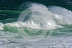 Wave crashing against rocks on the beach