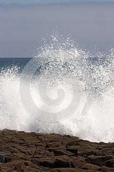 Wave crashing against the shore