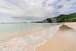 Wave crashing on beautiful beach in Ko Phayam island, Ranong, Thailand