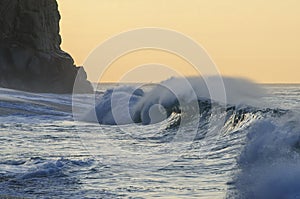 Wave crashing in Cabo San Lucas with Fishing boat in bg