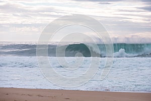 Wave crashing on a coast in Nazare, Portugal.