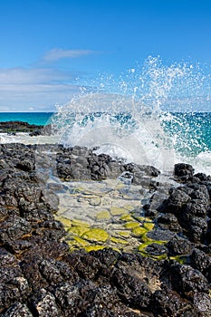 Wave crashing over a rock pool of basalt in Bunbury, Western Australia, Australia