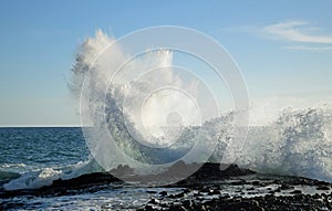 Wave crashing on rocks at West Street Beach in South Laguna Beach,California.