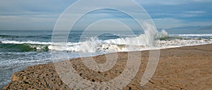 Wave crashing at the Santa Clara river estuary with lowering water level at the river mouth in Ventura California USA