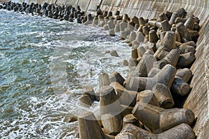 Wave dissipating tetrapod sea defenses along the coastline