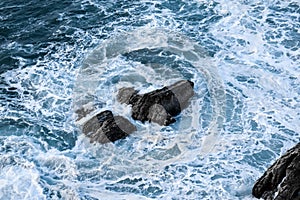 Rocks amongst the waves at the Cantabrian Sea photo