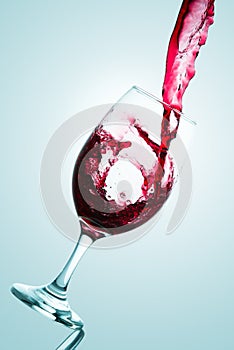 Wave formed on the pouring of red wine on a tasting glass