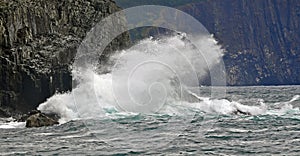 Wave hitting cliff walls in Middle Cove Newfoundland