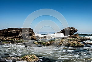 wave hitting rocks on a sea shore