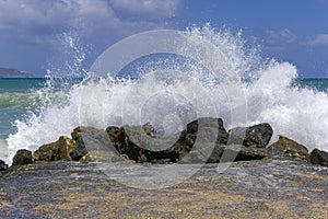 Wave overwhelming seaside, splashing around on road.