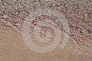 Wave on pink sand beach