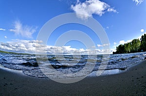 Wave rages and runs to the shore, fish-eye