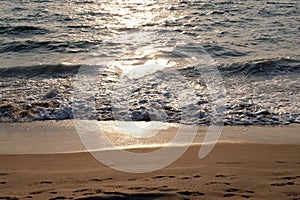 Wave rolling over the sands on Candolim Beach, Goa, India