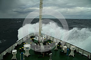 Wave rolling over the snout of the ship