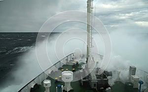 Wave rolling over the snout of the ship