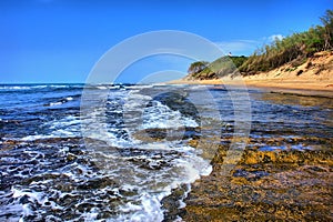 Wave runs on beach photo
