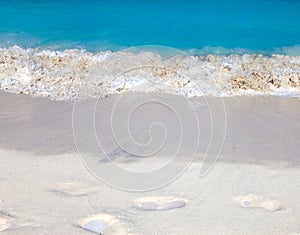 The wave runs on the coast and traces on sand