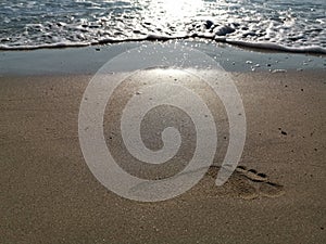 Wave on the sand beach - footprint