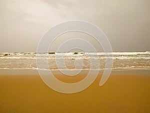 Wave on the sand beach in the morning time